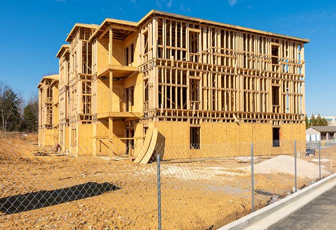 a close-up of temporary chain link fences enclosing a construction site, signaling progress in the project's development in Falkville